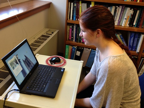 A woman uses CameraMouse eye tracking to navigate her computer.