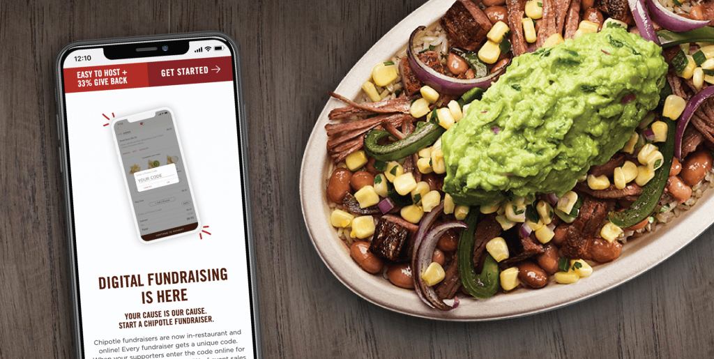 Mobile phone shows the Chipotle fundraising page and is face-up on the page next to a Chipotle burrito bowl.